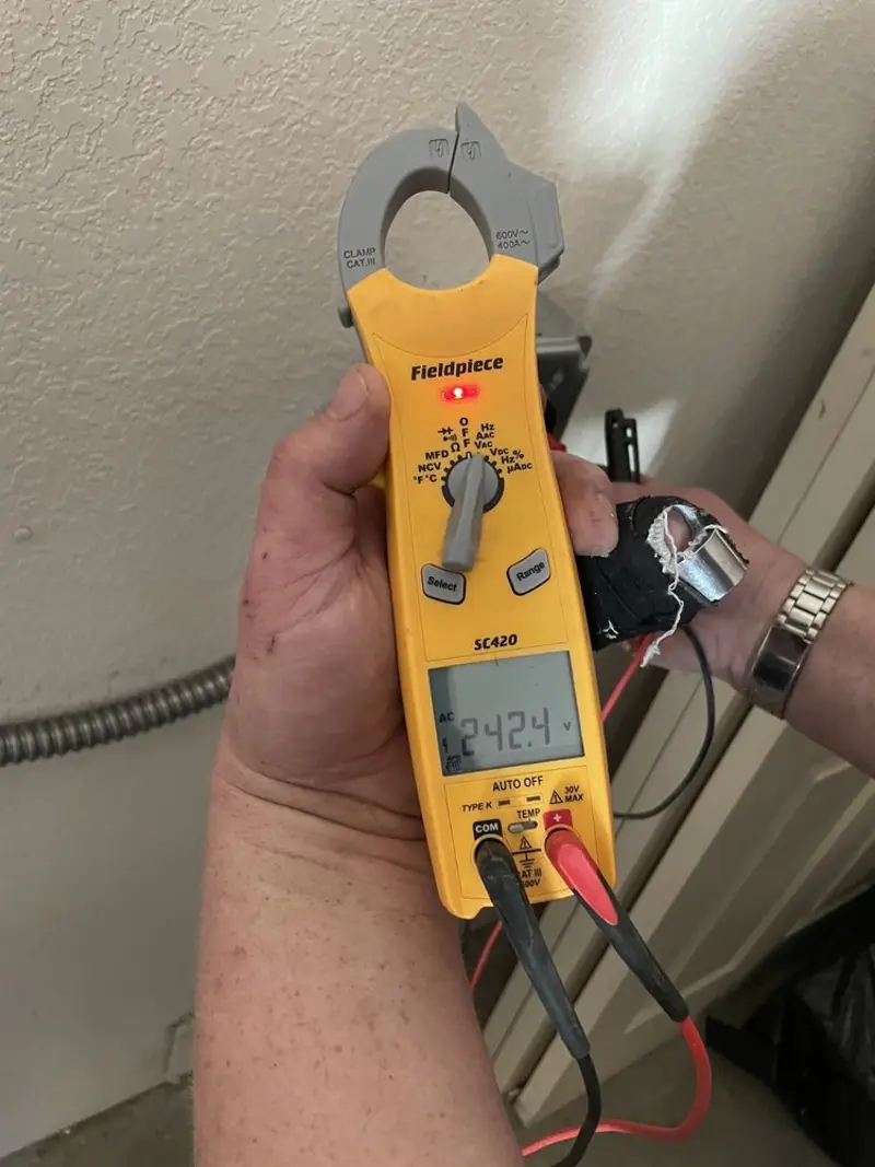 Voltage testing with clamp meter during Recessed Lighting Installation in Greenville